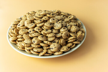 A plate of round shaped chocolate flavored flakes