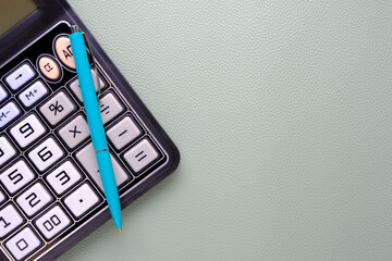 Calculator with a ballpoint pen on a leather texture background.