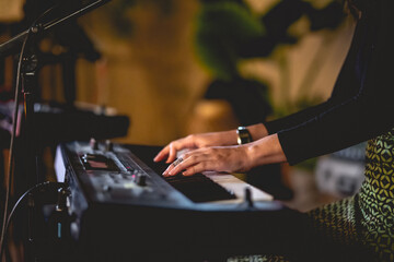 Closeup of keyboardist hands playing live in a big keyboard