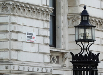 Downing Street sign on a wall in Westminster, London, UK. 