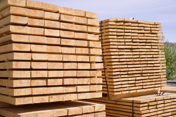 Stack of fresh pine boards in a sawmill warehouse. Harvesting, sale of lumber for construction	