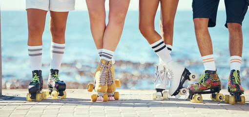 Roller skates, friends and beach with a group of people on the promenade at the beach with the sea...