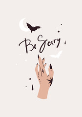 Card with lettering be scary. Female hand with magician tattoo, bat silhouette and moon shape. Contemporary art