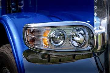 The unique headlight of a Semi Truck.  A breathtaking blue truck with stunning teardrop headlights...