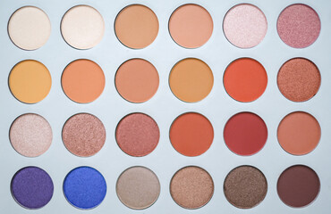 Selective focus of eyeshadow palette with various colors in pearly and matte closeup