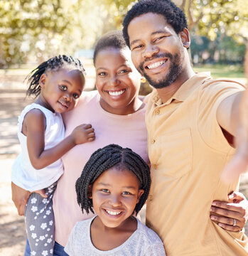 Happy black family take a selfie in nature on a holiday vacation trip together enjoy quality time at a kids park. Smile, happiness and African girls love taking pictures with their mother and father