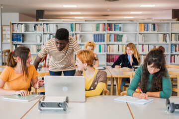 Group of students of different nationalities studying together in the university library