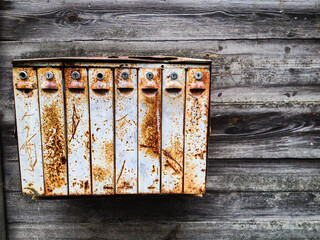 Old rusty mailbox on a wooden background. Vintage. 