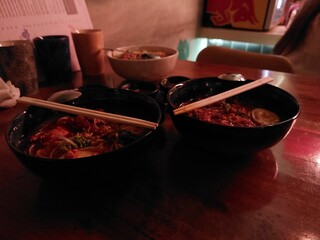 soy sauce ramen in bowl with chop sticks in restaurant, selective focus, blur background