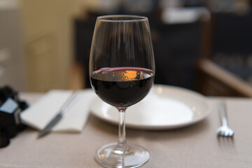 glass of red wine on a restaurant table