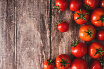 Tomatoes on old wooden table, fresh red tomato vegetables flat lay with copy space