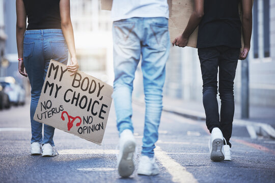 Global, Freedom And Protest March For Abortion Rights With Board Sign And Activism In A Street In Urban City. Pro Choice, Pro Abortion And Female Empowerment Posture With Crowd Fighting For Change