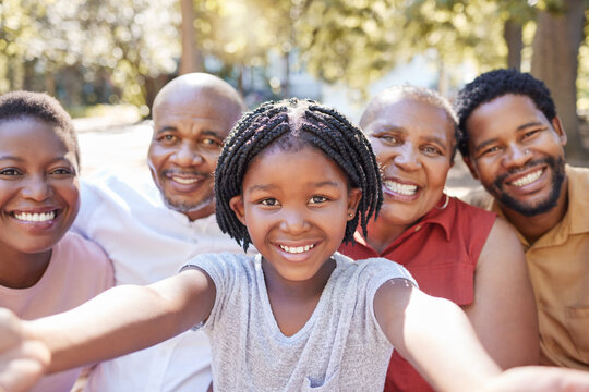 Black family, selfie and smile of child taking a picture with her parents and grandparents outside at a park in nature. Portrait of a girl having fun, love and bonding with family feeling happy