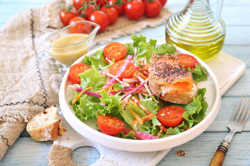 Lettuce salad with red fish, raw vegetables and olive oil. Red fish sandwich with rye bread, poppy seeds and mustard sauce