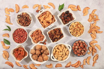 Assortment of various nuts and dried fruits, healthy natural food concept, almonds, nuts, pecans, pistachios, cashews, walnuts and pine nuts, apples, raisins, dried apricots, f