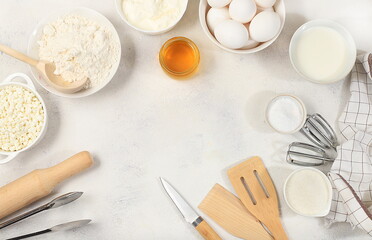 Kitchen background for baking and cooking cake, bread, confectionery and ingredients for cooking, milk, honey, flour, salt, sugar, eggs and cream on a concrete background with space for text