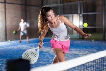 Padel tennis woman in court ready for play and train - obrazy, fototapety, plakaty