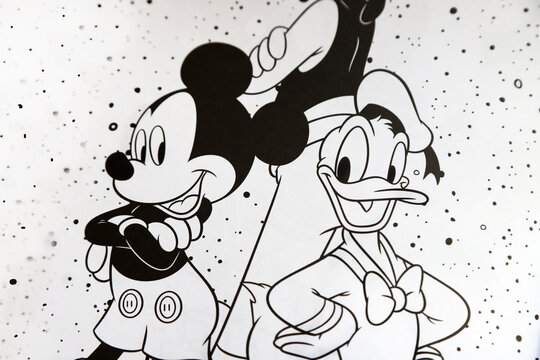 
Disney coloring magazine. Mickey Mouse, Goofy and Donald Duck in their classic outfits. White background and black lines. 