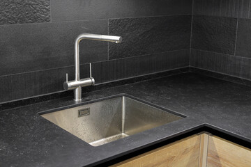 Faucet and steel sink in the kitchen