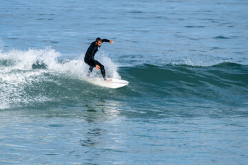 Surfer riding waves