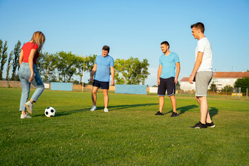 Group of people deferent age playing soccer for fun, team building