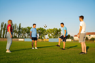 Group of people deferent age playing soccer for fun, team building