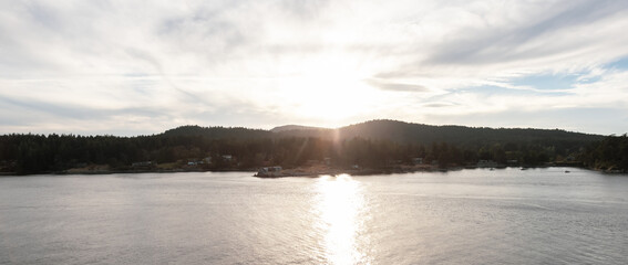 Canadian Landscape by the ocean and mountains. Summer Season Sunset.