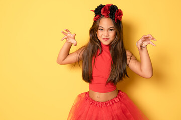 Portrait of an angry little girl in a costume, on a yellow background. halloween.