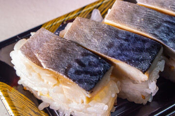 Takeout Saba Sushi (Saba Oshizushi, Mackerel Pressed Sushi) in plastic food container. Oshi Zushi...