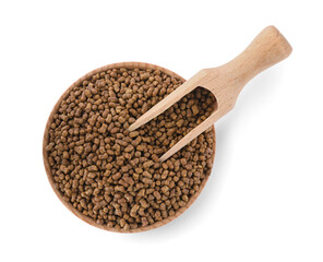 Wooden bowl and scoop with buckwheat tea granules on white background, top view