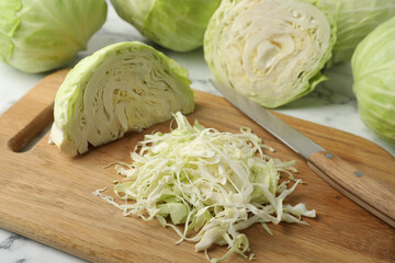 Chopped ripe cabbage on wooden board, closeup