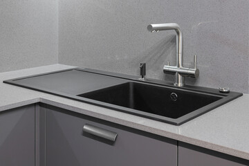 Faucet and granite sink in the kitchen