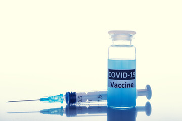 coronavirus vaccine with a syringe on a white background. the concept of mandatory vaccinations