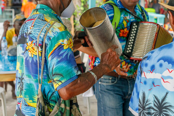 Dominican Republic. The beach musician plays the guiro. Merengue music. Traditional Latin American...