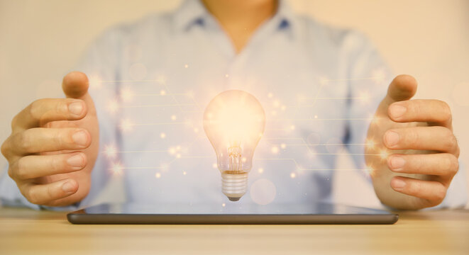 businessman holding a light bulb graphic Digital technology abstract. idea Creative