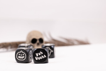 Magic dices with symbols for fantasy games and a skull and feather