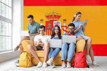 Students with modern devices indoors. Concept of studying Spanish - obrazy, fototapety, plakaty