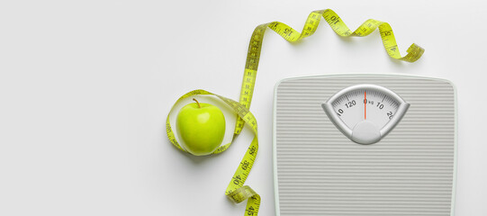 Scales and measuring tape with apple on white background. Weight loss concept - Powered by Adobe