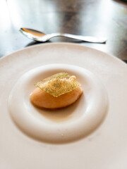 A palate cleanser of peach sorbet on a plate