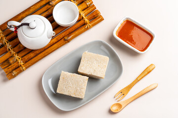 Raw Turnip cake (Chinese : Chai tow kway ). Turnip cake  is a common dish or dim sum of Teochew cuisine in Chaoshan, China usually cut into rectangular slices and sometimes pan-fried before serving.