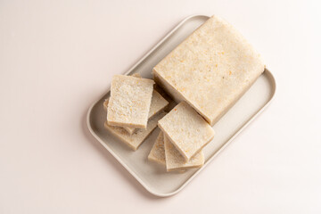 Raw Turnip cake (Chinese : Chai tow kway ). Turnip cake  is a common dish or dim sum of Teochew cuisine in Chaoshan, China usually cut into rectangular slices and sometimes pan-fried before serving.