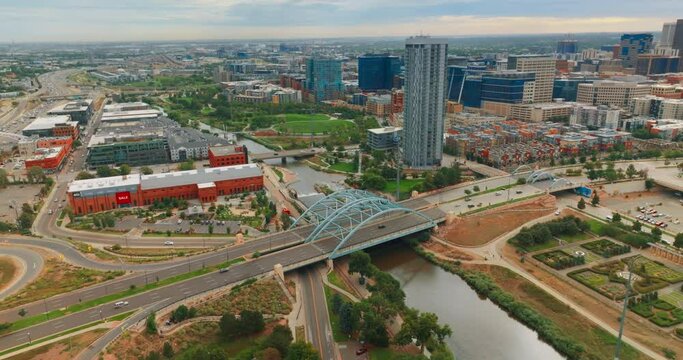 South Platte River flowing through gorgeous Denver, Colorado, USA. Panorama of the city on gloomy daytime from aerial view.