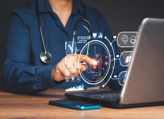 Hand of a doctor touching an image of a colon symbol on a virtual screen while sitting in the hospital