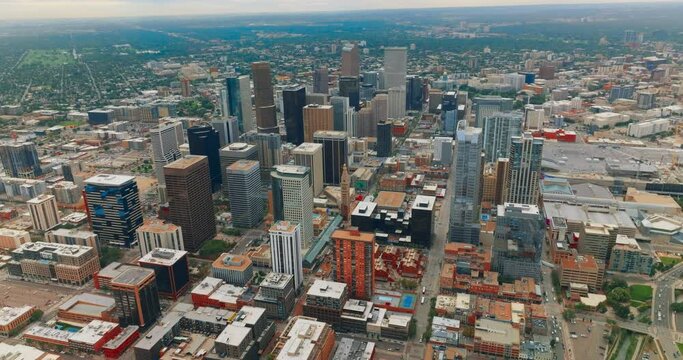 Gorgeous view of skyscrapers in the downtown of beautiful Denver, Colorado, USA. Metropolis centre at backdrop of green city at daytime from bird's eye view.