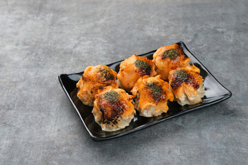 Dimsum with Japanese Mentai Sauce. Served on plate.
