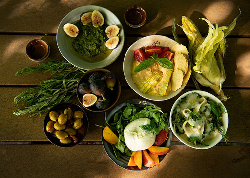 Picnic foods - salads, dips,  fruits, burrata cheese & olives 
