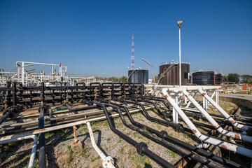 Industrial zone, Steel pipelines, valves, oil tank, cables and walkways
