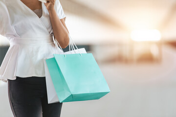 woman shopping. woman shopping in mall. woman shopping. person holding shopping bags.