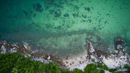 Aerial top view to the green azure sea coast
