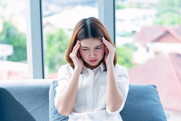 Fototapeta premium Stress asian women headache have migraine feeling temples stressfull upset depressed. Strong headache migraine exhausted young girl. Office syndrome unhealthy Tension person. Woman headache concept